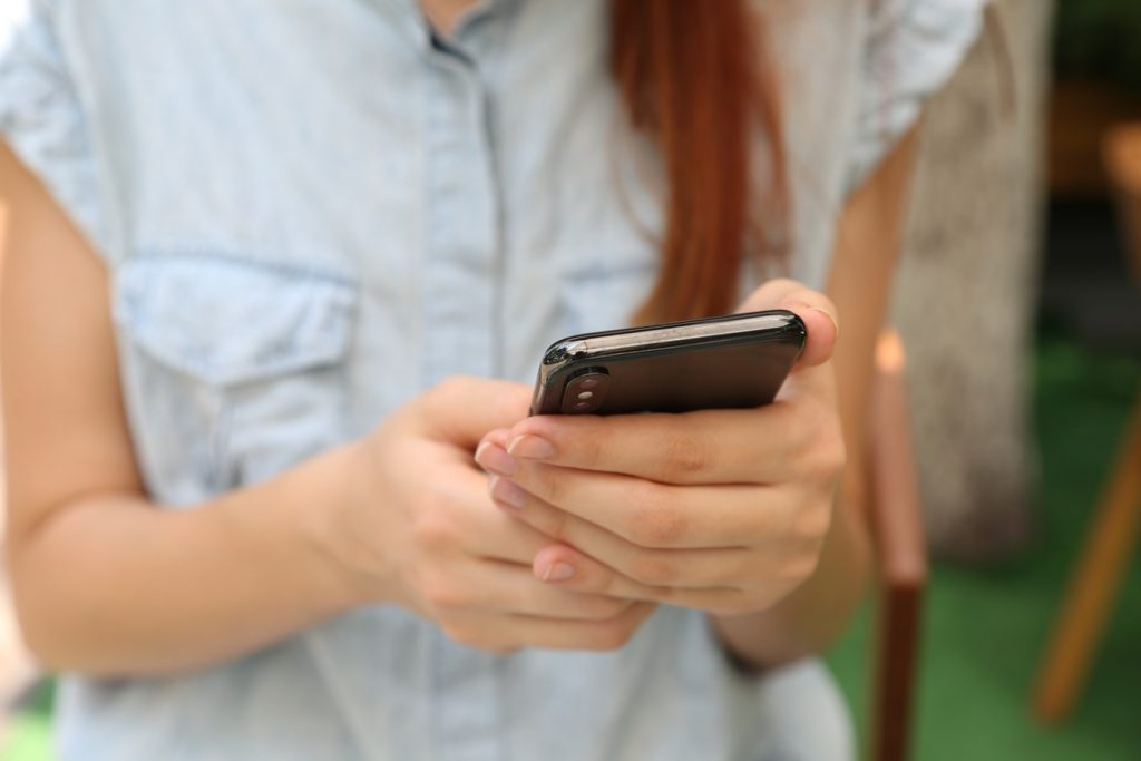 What makes a website mobile friendly with woman holding smartphone
