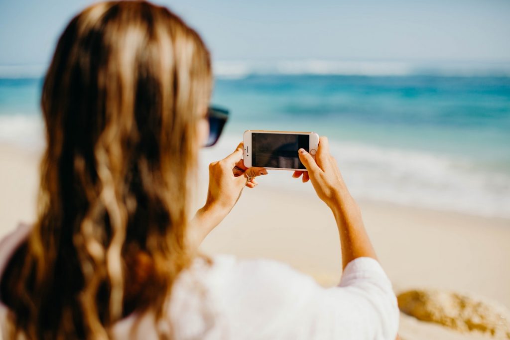 Influencer taking photo of the beach
