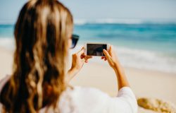 Influencer taking photo of the beach
